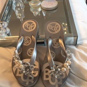 Some sandals with crystals and pearls on them